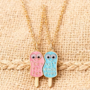 Macro shot of magnetic popsicle best friends forever necklaces with heart shape detail