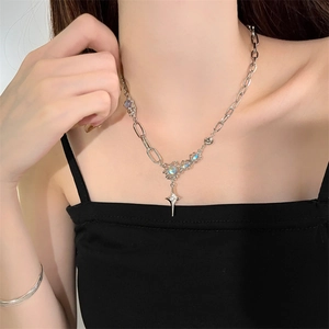 Close-up of moonstone starburst pendant necklace with asymmetrical silver chain on model