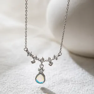 Macro detail of teardrop moonstone pendant with sparkling zirconia on a silver chain