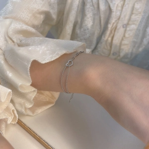 Detail of silver heart bracelet with double layer chain and adjustable lobster clasp