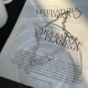 Detailed view of moonlight stone cross necklace with silver chain and star pendant