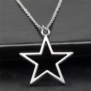 Minimalist silver hollow star pendant necklace with polished finish on black leather base