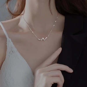 Elegant silver snake spiral wave necklace with zircon stones on a model for women