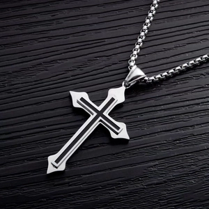 Detail of silver titanium cross pendant with black inlay and square box chain