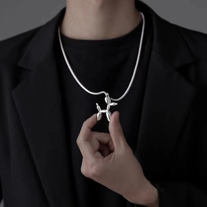 Polished silver balloon dog pendant with snake chain necklace worn by a fashion model