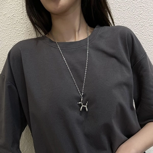 Polished silver balloon dog pendant necklace worn on a gray shirt for daily styling