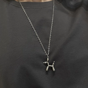 Silver balloon dog pendant on a sleek titanium steel chain worn over a grey sweater