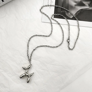 Detailed view of silver balloon dog pendant on high-polished stainless steel link chain