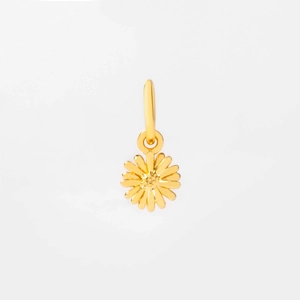 Close-up of a golden daisy pendant with detailed metal petals and a textured center