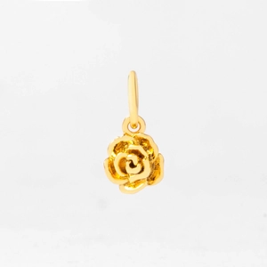 Macro shot of gold-plated rose flower pendant showing layered metal petals and ring