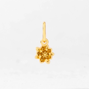Detailed view of layered golden flower pendant with intricate petals and central stamen