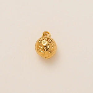 Macro shot of 18K gold plated sphere pendant with hammered texture and top ring loop