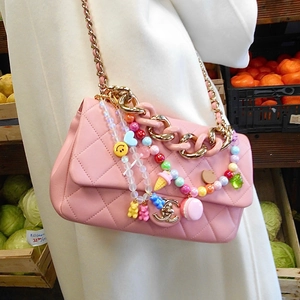 Pink quilted bag detail with colorful DIY beaded charms like ice cream and hearts