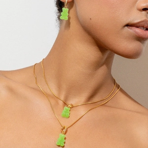 Chic gold jewelry set with translucent green gummy bear pendants and sparkling diamonds