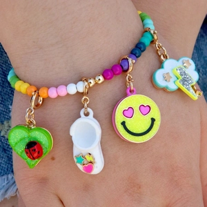 Rainbow beaded bracelet featuring fruit, smiley face, and cloud charms in dopamine style