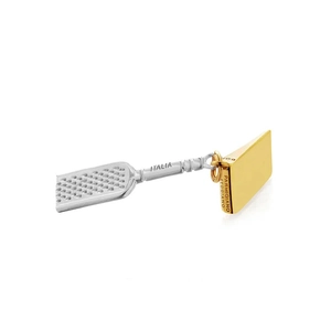 Detailed charm of a silver grater and golden cheese wedge with fine engraving