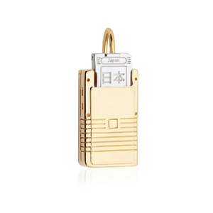 Macro detail of retro game console pendant with Japan engraving in gold and silver