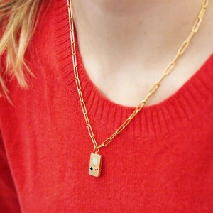 Golden paperclip chain necklace featuring a vintage handheld game console pendant