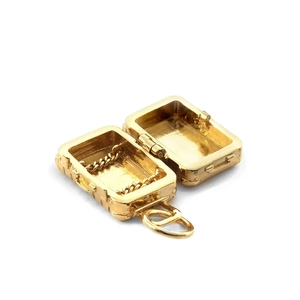 Golden suitcase charm pendant with flip-top opening and internal chain detail