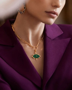 Close-up of gold paperclip chain necklace with malachite evil eye pendant on model