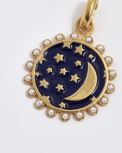 Detailed close-up of vintage gold celestial pendant with blue enamel, moon, stars and pearls