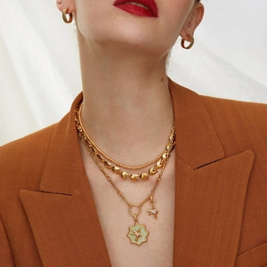 Three-layer 14k gold plated necklace set with bird and zircon charms on female model