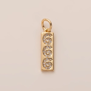 Detailed close-up of 18K gold rectangular pendant with spiral diamond-set patterns
