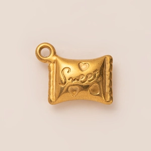 Detailed close-up of a 18K gold-plated candy-shaped pendant featuring Sweet engraving