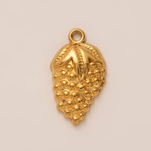 Macro detail of strawberry shaped 18K gold plated stainless steel pendant texture
