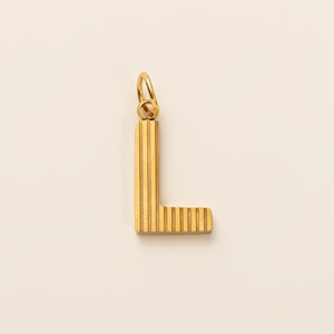 Macro shot of 18K gold letter L pendant with vertical textured lines and dual rings