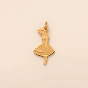 Detailed view of an 18K gold-plated dancing girl pendant on a soft pink background