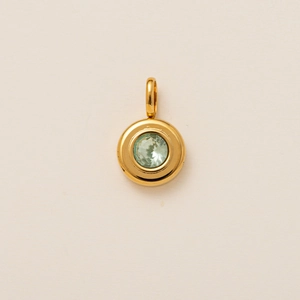 Detail of 18K gold plated stainless steel pendant with light green crystal in bezel setting