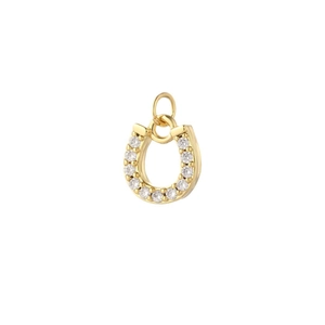 Macro view of a gold plated horseshoe pendant inlaid with bright circular zircon stones