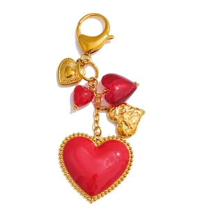 Detail of red heart keychain with multiple enamel pendants and gold bead borders