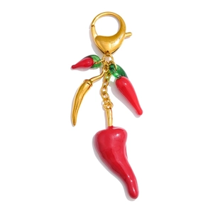 Detailed view of red chili pendants with golden lobster clasp and vibrant resin finish
