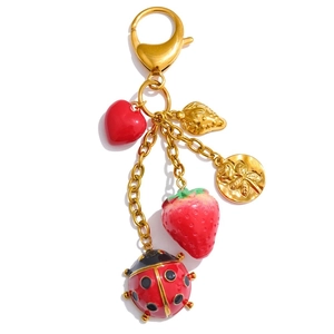 Chic gold keychain featuring red heart, strawberry charms and ladybug pendant accessories