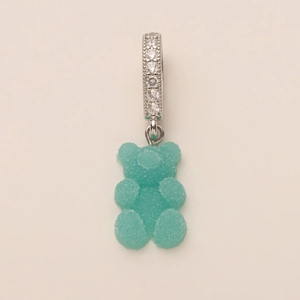 Macro view of blue gummy bear pendant with silver zircon ring and frosted texture