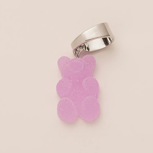 Macro detail of gummy-style resin bear charm with frosted pink-purple glitter finish
