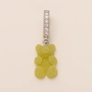 Detailed macro shot of a lime green gummy bear pendant with zircon paved silver buckle