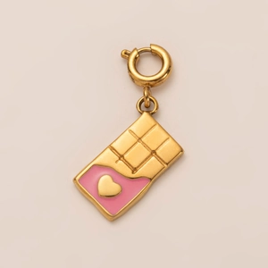 Macro detail of gold chocolate bar pendant with pink enamel heart and spring clasp link