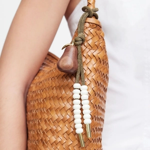 Brown leather woven handbag with green rope knot, pear wood charm and white beads