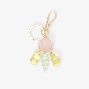 Detail shot of ocean shell pendant with pink seashell bead and gold metal clasp on white base