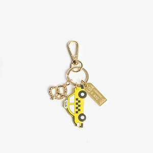 Detail of NYC themed keychain with yellow taxi, pretzel charm and golden LGA plaque