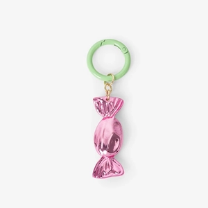 Close-up of pink candy-shaped metal keychain with light green circular buckle detail