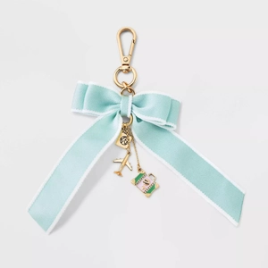 Blue satin bow keychain with gold 18K plated travel charms, passport, plane, and suitcase