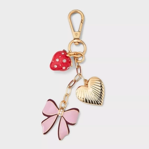 Golden keychain featuring 18K plated strawberry, heart, and pearl bow pendants