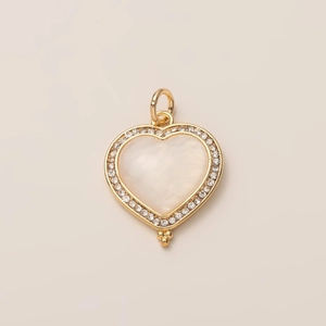 Detailed view of heart pendant with 14K gold plating, mother of pearl inlay and crystals
