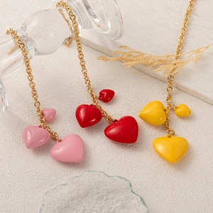 Golden heart pendant necklaces in pink, red, and yellow with resin finish for women