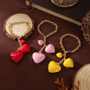 Three-tiered heart charms in red, pink, and yellow with gold chain and resin finish