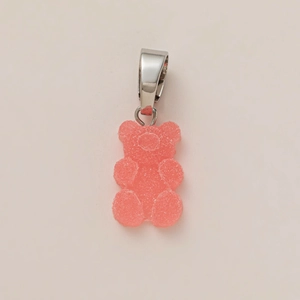 Close-up of pink gummy bear pendant with frosted texture and silver metal hook clasp